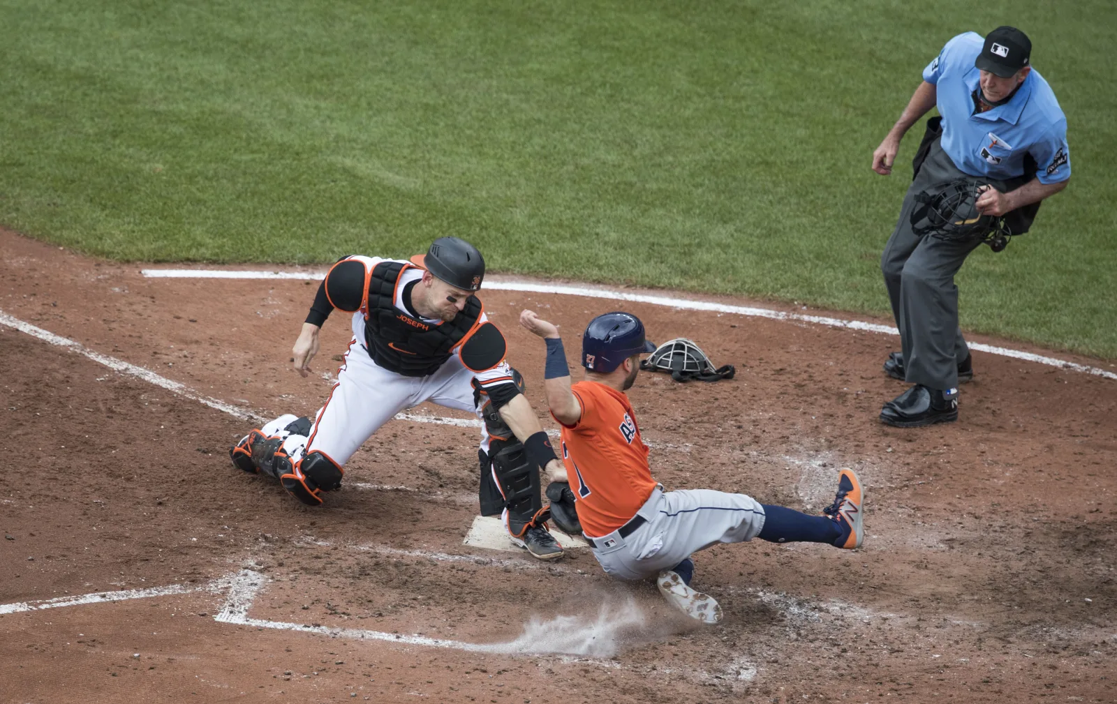 Caleb Joseph tags José Altuve at home plate with umpire Mike Winters watching, July 2017. Archive action, not an ABS challenge.