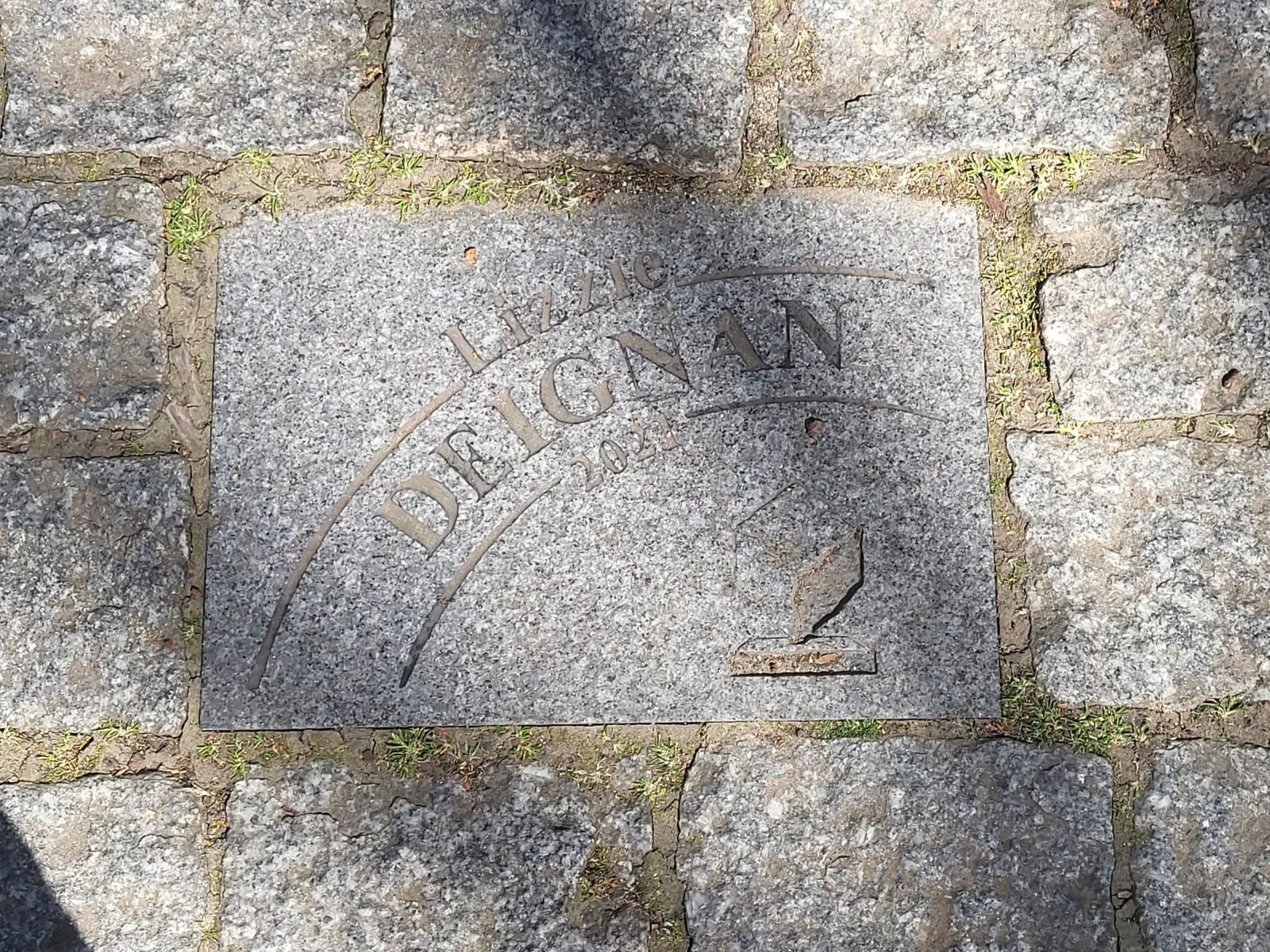 Commemorative cobblestone honouring Lizzie Deignan's 2021 Paris-Roubaix victory, photographed in April 2025.