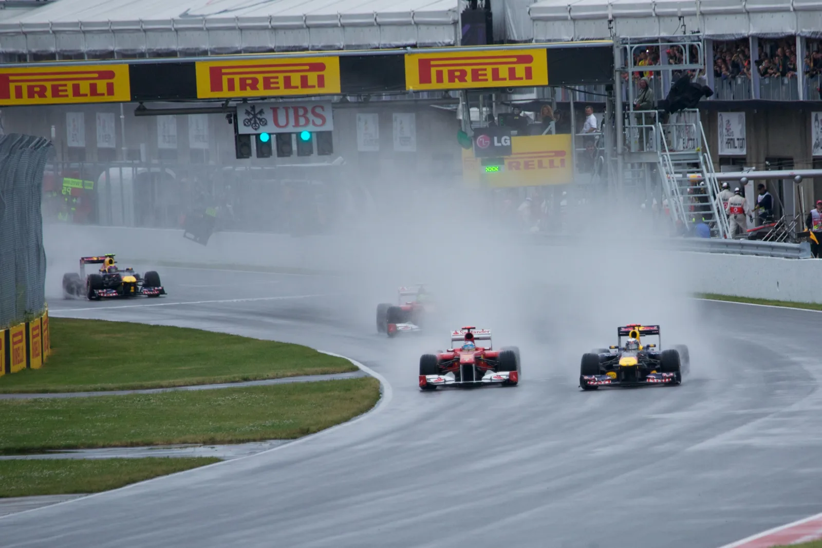 Formula 1 cars surrounded by spray on the wet circuit during the 2011 Canadian Grand Prix in Montreal.